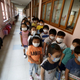 Students wait in a line outside their classroom at an elementary school in Seoul.